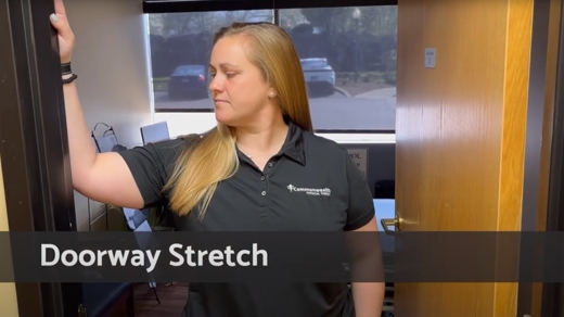 Woman performing a doorway stretch